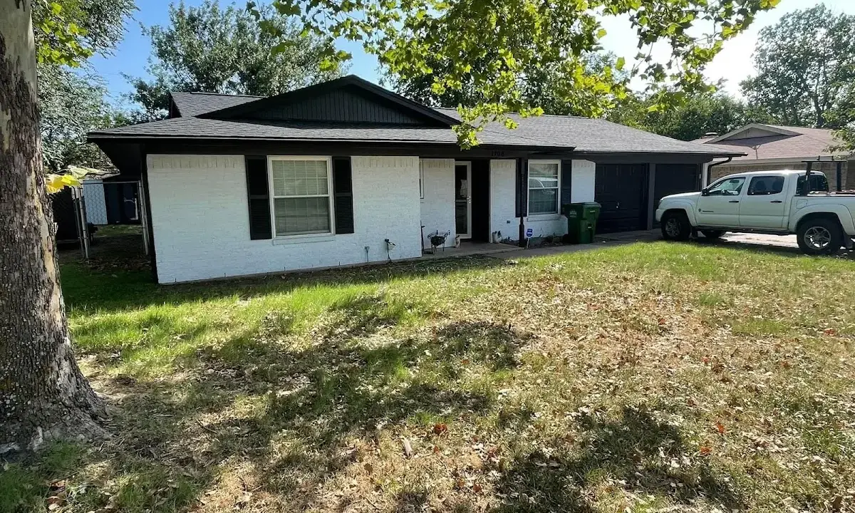 Professional roofing crew working on a residential roof in North Manchester